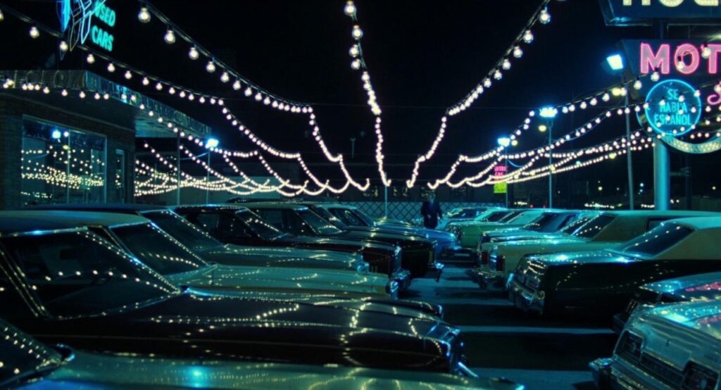James Caan's Frank surveys his neon-lit used car lot