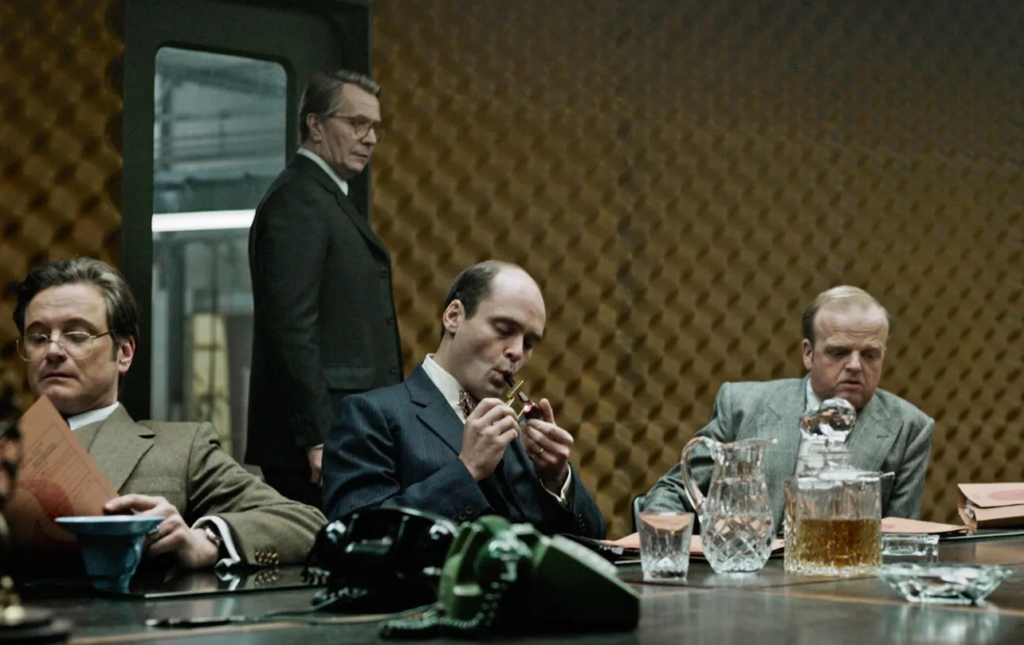 George Smiley looks suspiciously at the other members of the inner circle of British Intelligence