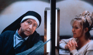 A man disguised as a nun hears confession from a woman