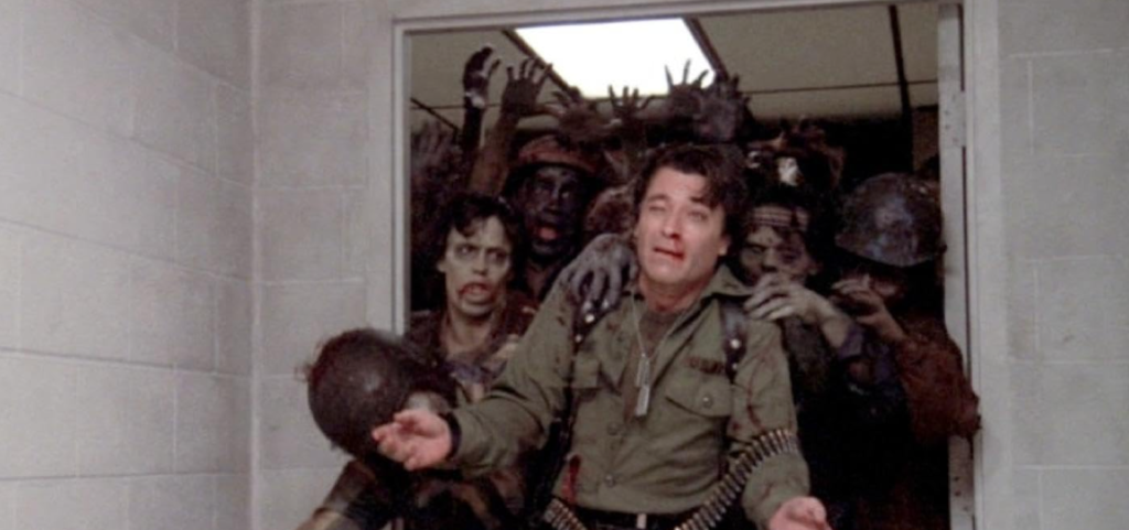 A soldier is pulled through a doorway by dozens of zombies