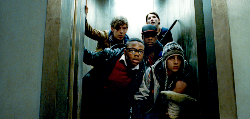 Four teens and a twentysomething nurse crouch in an elevator and nervously look out the door